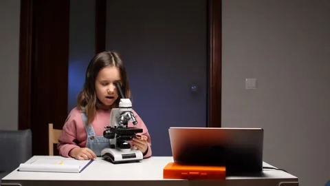 Girl exploring microworld discovering science through microscope research Stock Footage 319593793