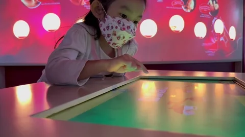 A girl exploring a touch screen interface Stock Footage 175682634