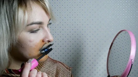 Girl with eye on lips doing makeup Stock Footage 98707365