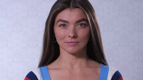 A girl with eyebrows in the shape of a triangle smiles. 4K Slow Mo Stock-Footage 109162100