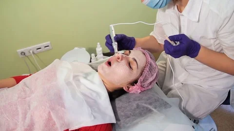 The girl face during the procedure bb glow. Grimace stretching of the skin. Stock Footage 83728587