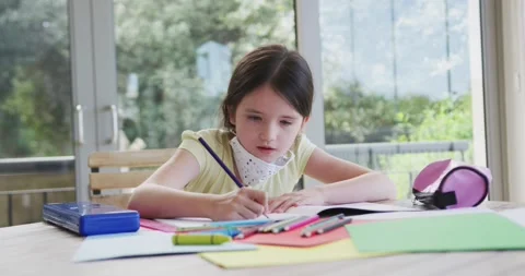 Girl in face mask does homework during Covid lockdown. Stock Footage 335865989