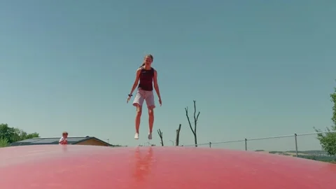 A Girl Falls on a Trampoline Stock-Footage 345877956