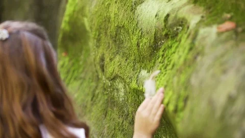 Girl with a feather between rocks Stock Footage 83536535