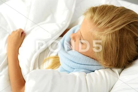 Girl with fever wearing scarf Stock Photos