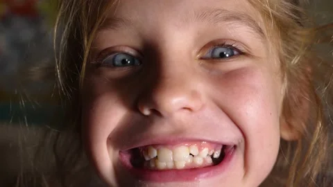 girl firmly clenches her teeth, then ope... | Stock Video | Pond5