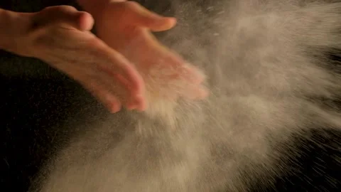 The girl flaps her hands and white dust appears Stock Footage