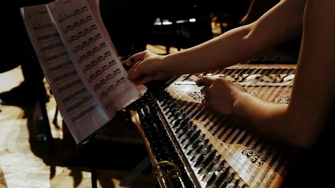 Girl flips white sheets with notes at a concert Stock Footage 121571692