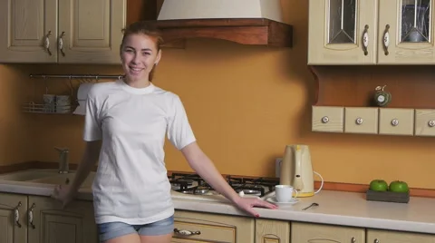 Girl flirting in the kitchen Stock Footage 47375637