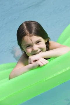 Girl on floatation device Foto stock
