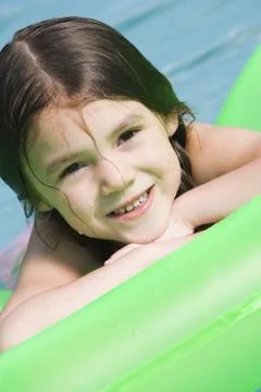 Girl on floatation device Foto stock