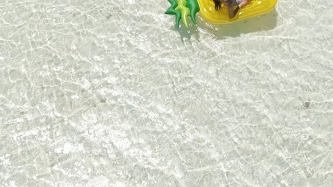 Girl floating on inflatable fruit ring. Space for Text Copy. 库存影片 126604845