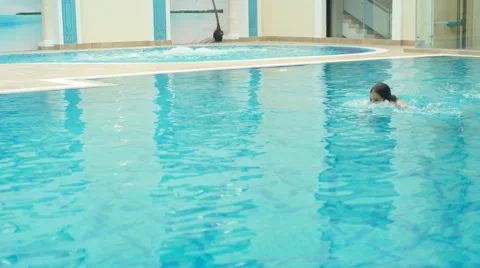 The girl floating in the pool Stock Footage 64310249