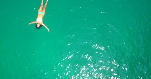 Girl floats in ocean phi phi thailand bikini Stock Footage 63361636
