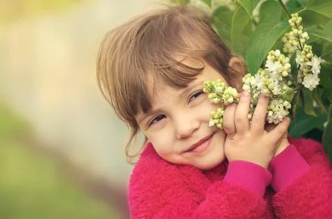 Girl with flowers in the spring outside. Selective focus. Stock Photos