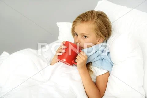 Girl with flu holding warm beverage Stock Photos