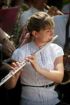 Girl with a flute. Brass band Stock Photos