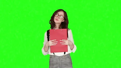 A girl with a folder on a green background Stock Footage 164618579