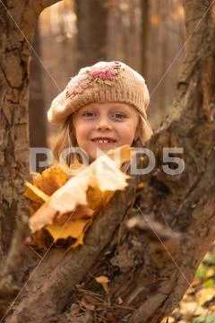 Girl in the forest in a brown cap in the fall with a good mood and bright eye Stock Photos