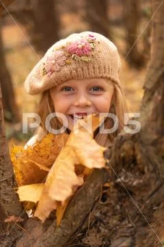 Girl in the forest in a brown hat in the fall with a good mood and bright eye Stock Photos