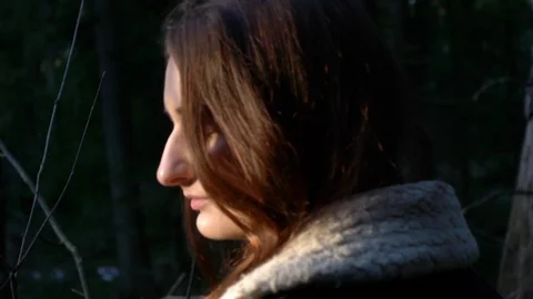 Girl in the forest, sun rays on the face Stock Footage 123147905