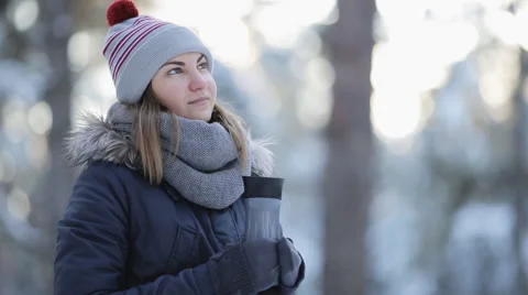 Girl in the forest with Thermocup breathing steam from the tea Stock Footage 59658678