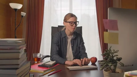 Girl freelancer student using computer, searching Internet, typing on keyboard Stock Footage 132889702