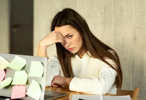 Girl in front of computer with task stickers Stock Photos