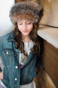 Girl in fur headband looking down Stock Photos