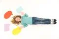 The girl gesture on the floor near the dialog signs. View from above Photo