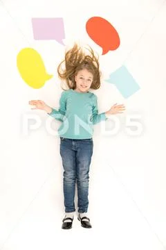 The girl gesture on the floor near the dialog signs. View from above Stock Photos