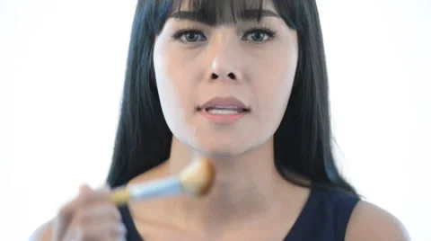 Girl gets blush on the cheekbones. Stock Footage 58464916