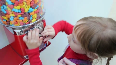 Girl gets candy from machine sale of sweets Stock Footage 44751975