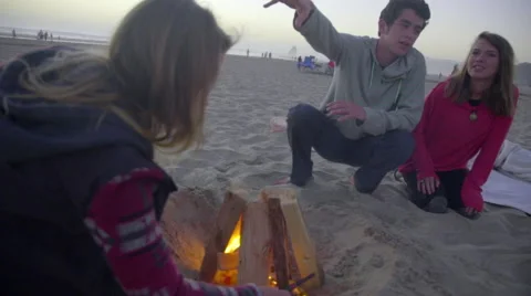 Girl gets fire going Stock Footage 53076989