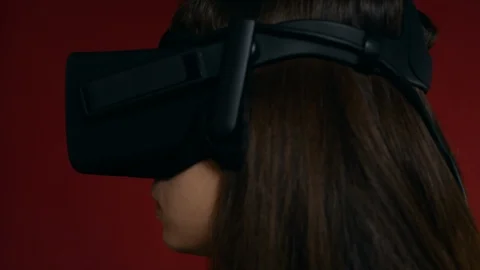 A girl gets scared while playing an immersive virtual reality experience Stock Footage 93686490