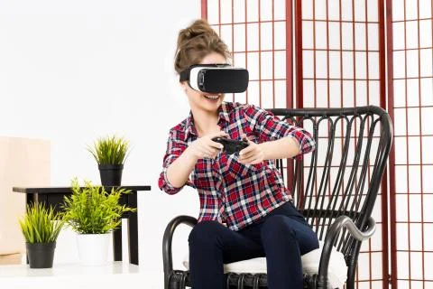 Girl getting experience using VR-headset glasses of virtual reality Stock-Fotos