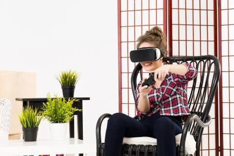 Girl getting experience using VR-headset glasses of virtual reality Fotos de archivo
