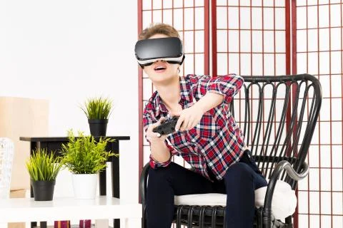 Girl getting experience using VR-headset glasses of virtual reality Stock-Fotos