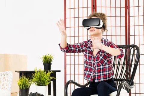 Girl getting experience using VR-headset glasses of virtual reality Stock Photos