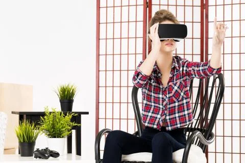 Girl getting experience using VR-headset glasses of virtual reality Fotos de archivo