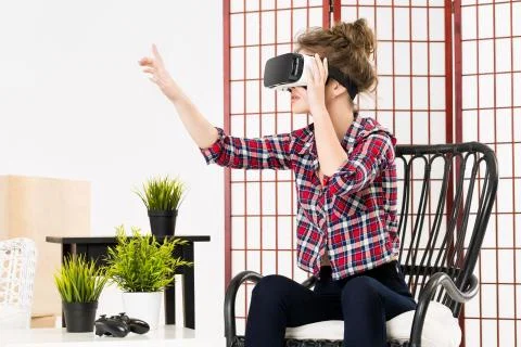 Girl getting experience using VR-headset glasses of virtual reality 写真素材