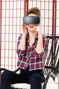 Girl getting experience using VR-headset glasses of virtual reality 写真素材