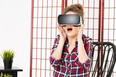 Girl getting experience using VR-headset glasses of virtual reality Stock Photos