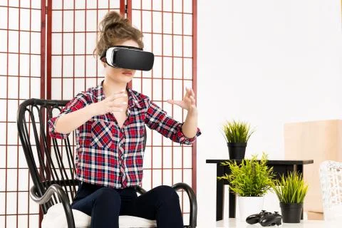 Girl getting experience using VR glasses of virtual reality Photos