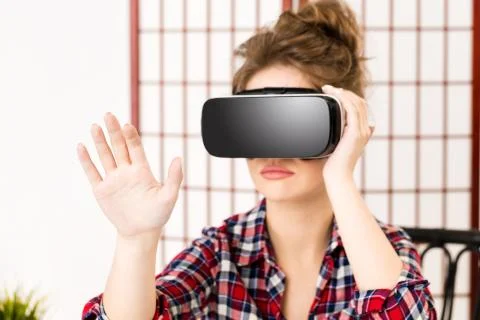 Girl getting experience using VR glasses of virtual reality Stock-Fotos