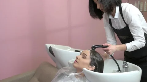 Girl getting her hair washed. Stock Footage