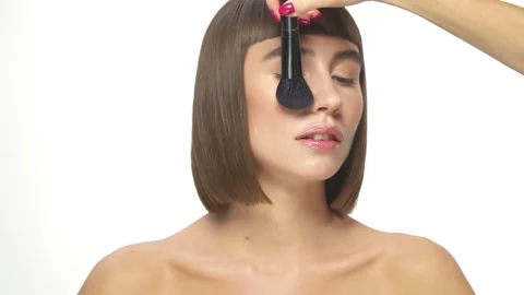 Girl getting make-up on white background Stock Footage 142809041