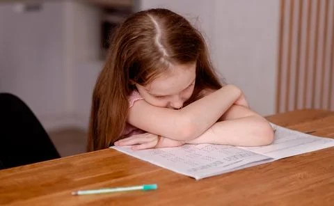 The girl is getting ready for school, learning to write and count Stock Photos