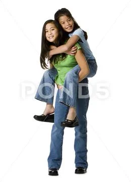 Girl Giving Piggy Back Ride To Younger Girl