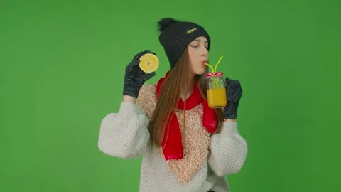 Girl with a glass of lemon juice keeping in her right hand a slice of lemon. Stock Footage
